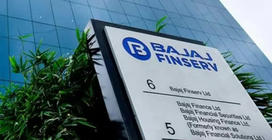 Bajaj Finserv headquarters signage with greenery and modern glass building in background.